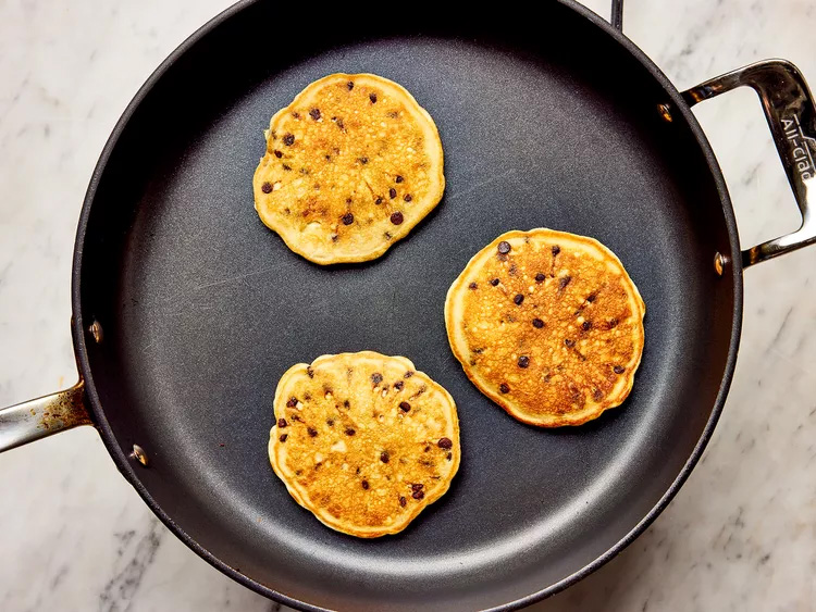 Flipped pancakes being cooked on griddle